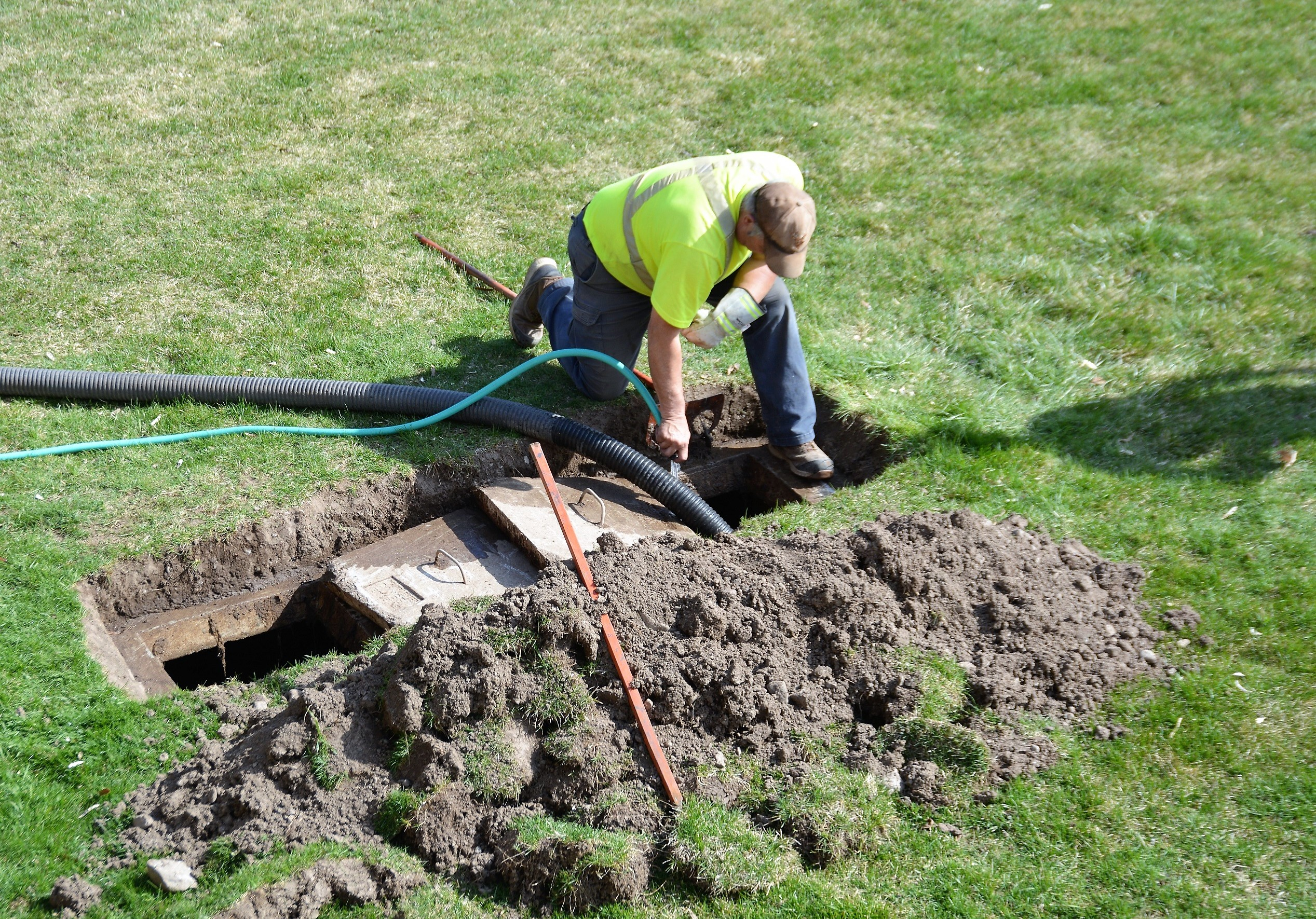 worker septic tank pumping