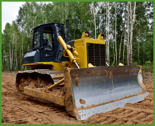 A bulldozer clearing a field of debris.